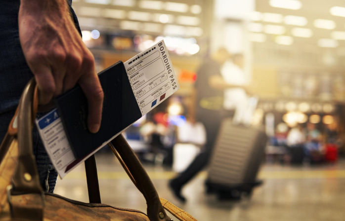 suitcase at airport with travel stickers